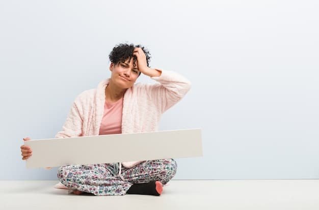 A person with their head in their hands, looking stressed and overwhelmed, sitting in front of a pile of bills and a laptop displaying debt figures. The scene is dimly lit, enhancing the feeling of anxiety.