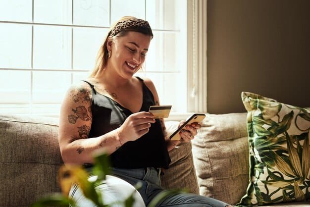 A person holding a credit card, overlayed with a smartphone displaying a debt payoff app tracking progress and showing motivational messages. The background is a cozy living room.