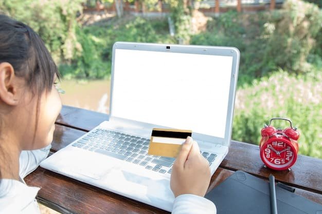 A person comparing credit card offers on a laptop screen, with multiple browser tabs open showcasing different interest rates and benefits. The person is holding a credit card in their hand.